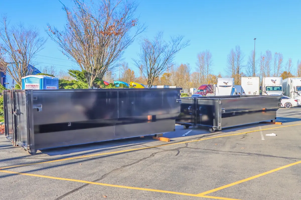 Professional dumpster rental service with roll-off container on residential driveway in Holmen